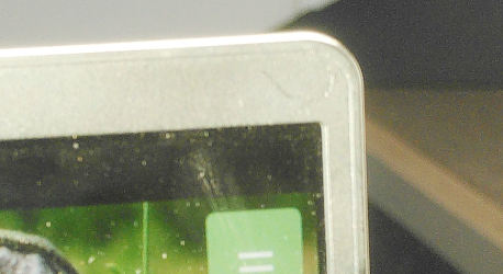 The upper right corner of a computer screen.  Between the lower border of the screen bezel and the top of the screen content, there is quite a bit of black space.