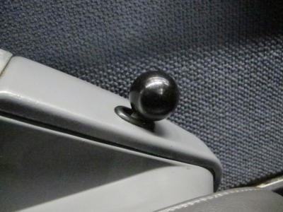 A lever with a black, spherical grip, protruding a few centimetres from some sort of console.