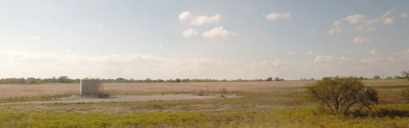 Paririe, an oil tank, and a high sky