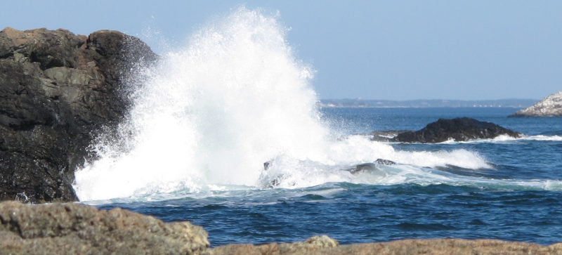 A cliff falling into the see with a mighty splash.