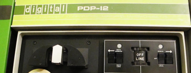 Type plate of a DEC PDP 12 minicomputer.  A large rotary switch is set to offline.