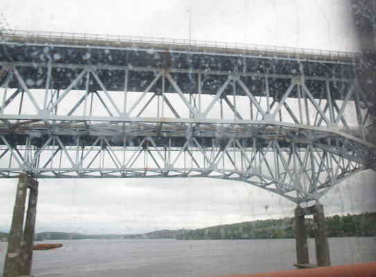 A high-rising bridge across a wide river.
