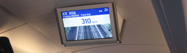 A ceiling-mounted display saying “310 km/h”.